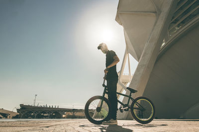 Man performing stunt on bicycle in city 