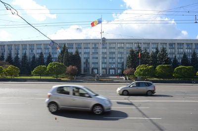 Cars on street against buildings in city