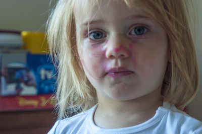Close-up portrait of cute girl with make-up at home
