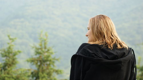 Rear view of woman looking at camera