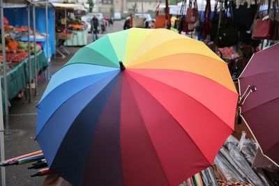 Close-up of multi colored umbrella in market for sale