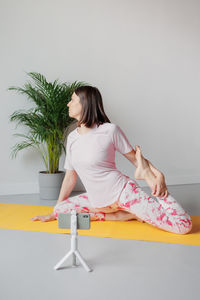 Young woman sitting on floor