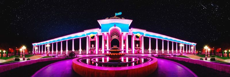 Illuminated building against sky at night