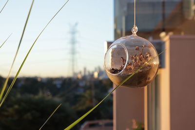 Close-up of bell hanging against sky