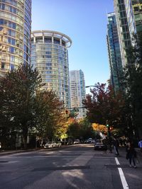 City street amidst buildings against clear sky