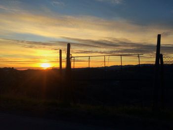 Scenic view of silhouette field against sky during sunset