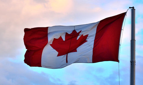 Low angle view of flag on pole against sky