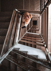 Portrait of young man standing on staircase