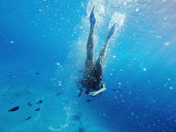 Reflection of person swimming in sea