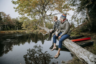 Full length of men on lake against trees