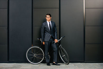 Full length of a young man with bicycle