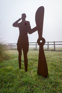 Man standing on field against clear sky