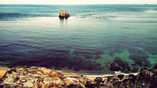 Scenic shot of headland in calm blue sea