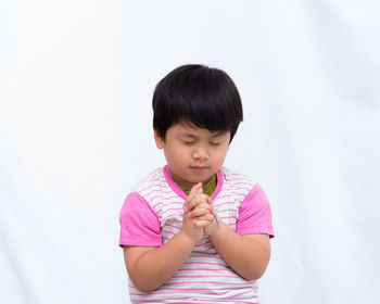 Cute girl looking away over white background