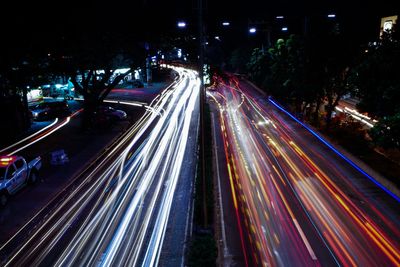 High angle view of light trails on road at night