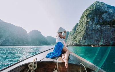 Woman on longtail boat in sea