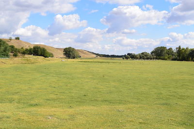 Scenic view of golf course against sky