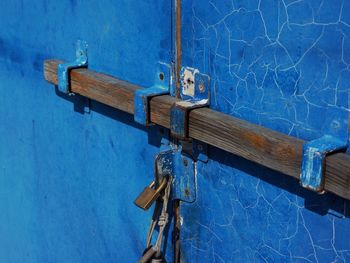 Close-up of padlocks on blue metallic structure 