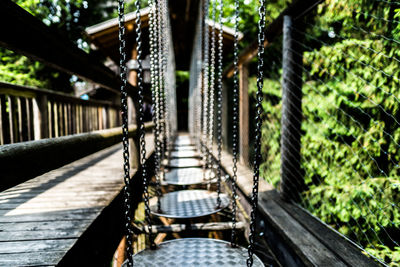 Footbridge amidst trees in forest
