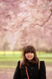 Portrait of smiling beautiful woman in park