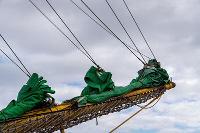 Cropped image of boat against cloudy sky