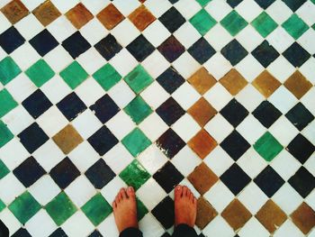 Low section of multi colored pattern on tiled floor