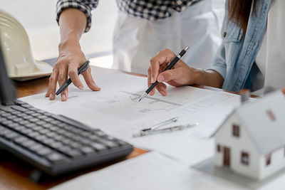 Midsection of woman working on table