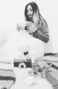 Portrait of woman holding mobile phone