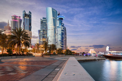 Skyscrapers on shore at dusk