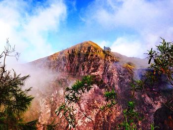 Scenic view of mountains against cloudy sky