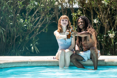 Couple sitting in swimming pool