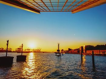 Scenic view of river against sky during sunset