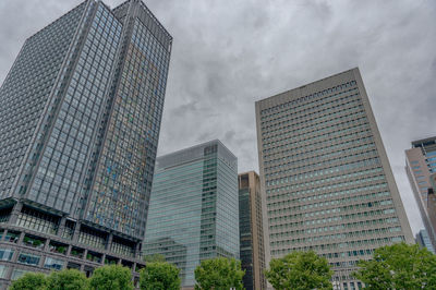 Low angle view of modern buildings against sky in city