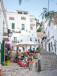 People on street amidst buildings in city