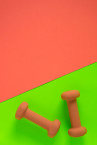 Close-up of hand holding toy against red background