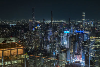 Illuminated cityscape against sky at night