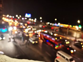 Defocused image of illuminated city street at night