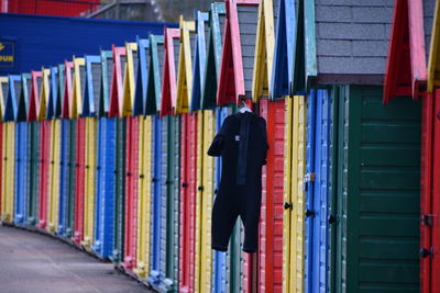 Rear view of man standing in multi colored pencils