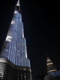 Low angle view of illuminated building against sky at night