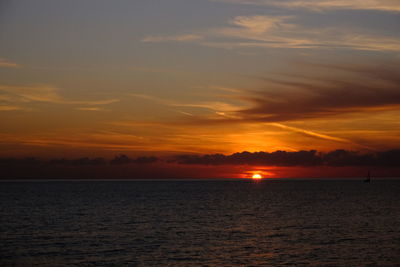 Scenic view of sea against romantic sky at sunset