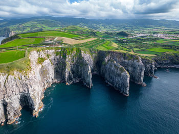 High angle view of sea and mountains against sky