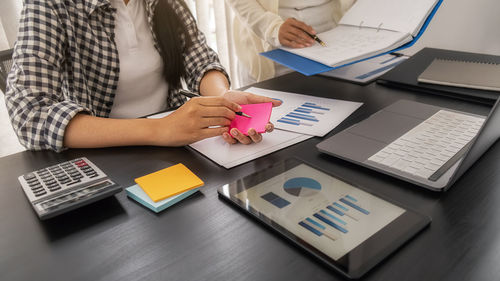 Low angle view of woman using laptop on table