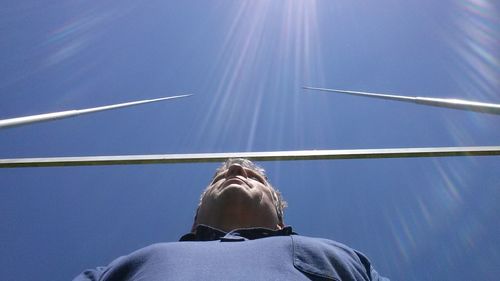 Rear view of man against blue sky