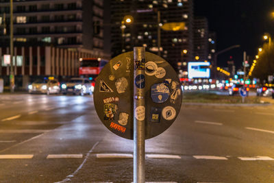 Illuminated clock on road in city at night