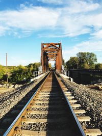 View of railroad tracks against cloudy sky