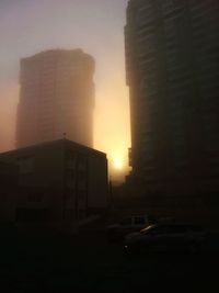 Buildings in city at sunset