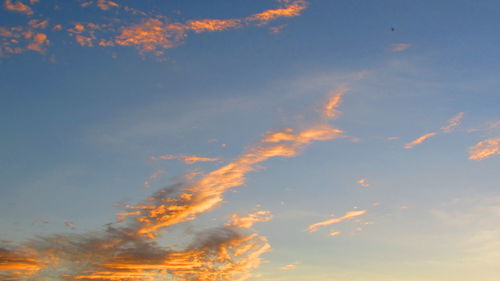 Low angle view of cloudy sky at sunset