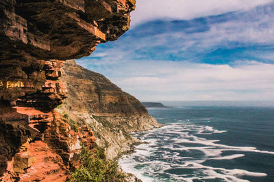 Scenic view of sea and mountains against sky