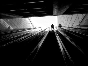 Rear view of man on escalator