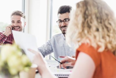 Smiling young professionals working in office